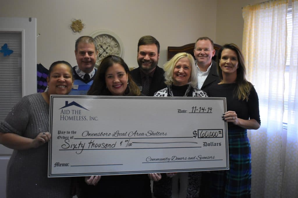 Aid the Homeless presents a check at Oasis